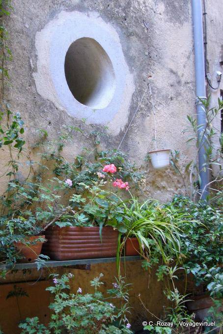 Ramatuelle, Bullauge in der Wand und Blumen, Provence, Frankreich