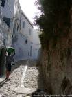 Gepflasterten Straße Kopfsteinpflaster und Kind das Tragen der Kleidung auf dem Kopf, Chefchaouen, Marokko.