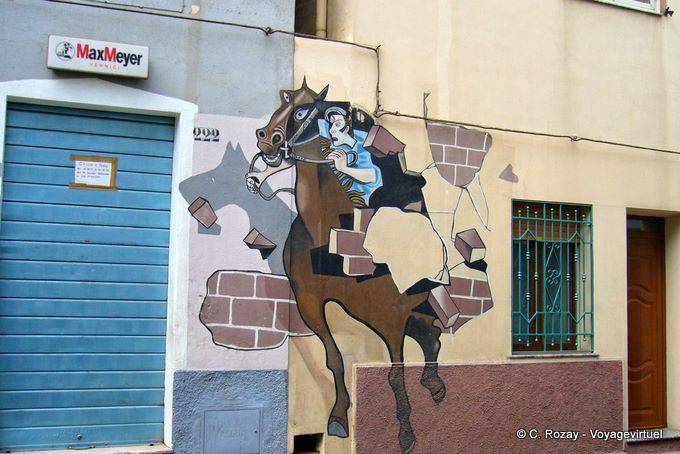 Orgosolo, der Fahrer brechen die Wand (danach Il Palio), Wandmalerei - Sardinien
