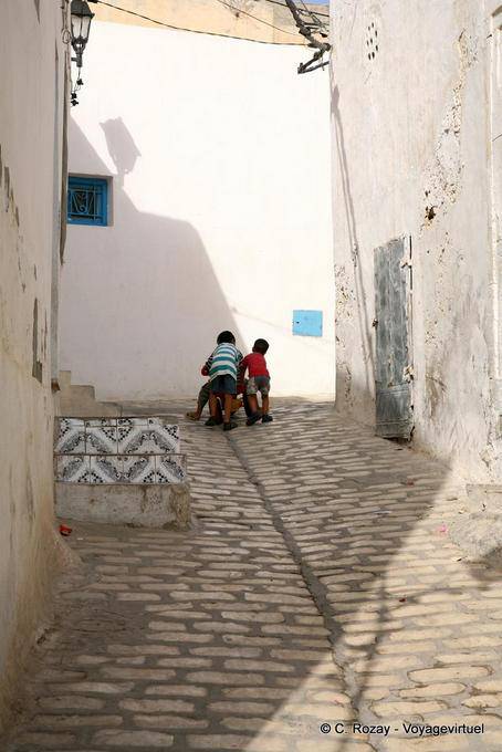 Kinder spielen auf dem mittelalterlichen Kopfsteinpflaster, Sousse Medina - Tunesien